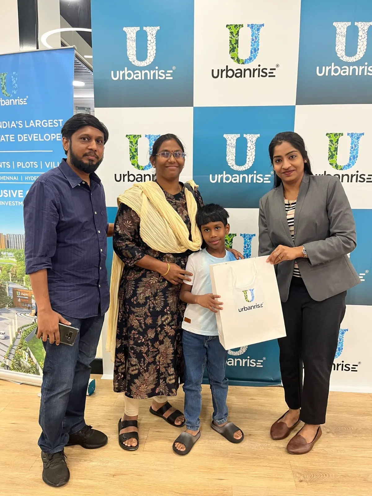 A family with their child receiving a welcome bag