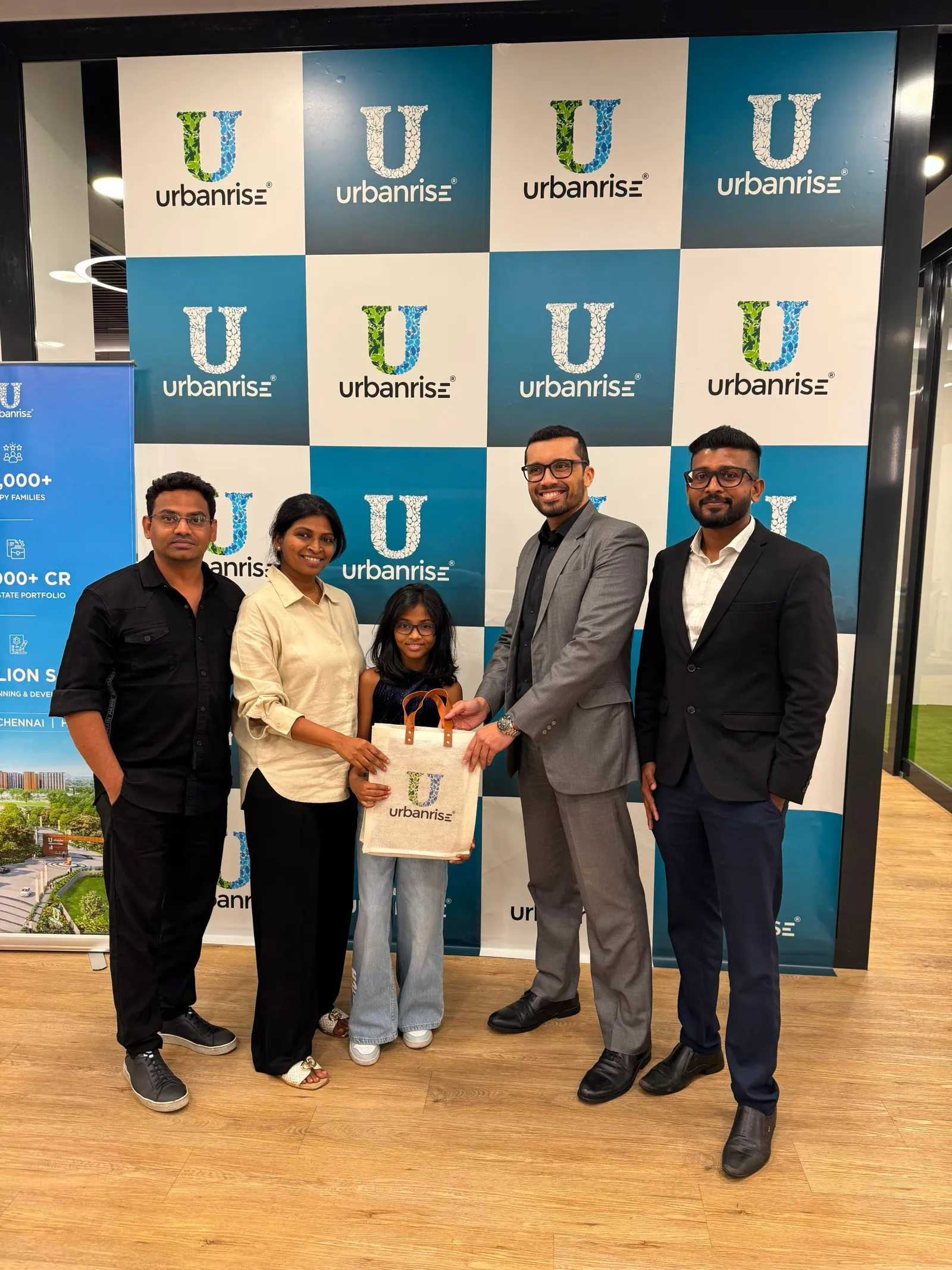 A family with their daughter receiving an Urbanrise bag