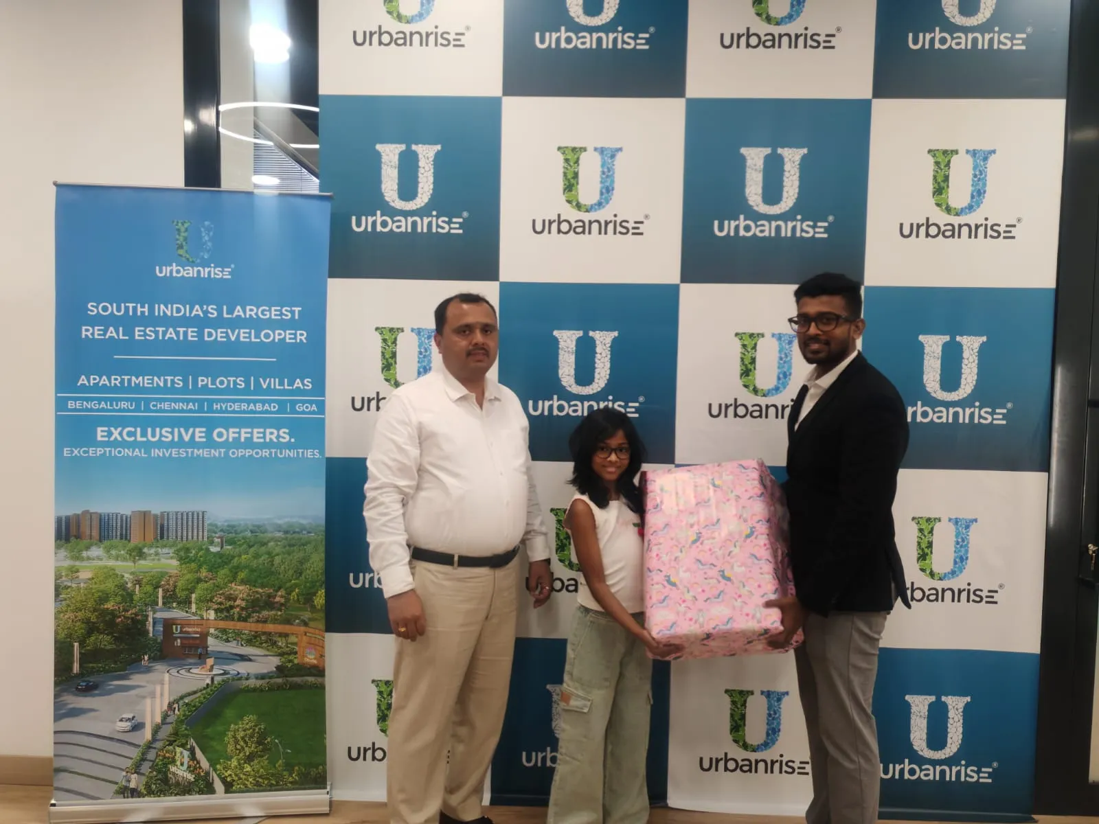 A young visitor receiving a gift from the Urbanrise team